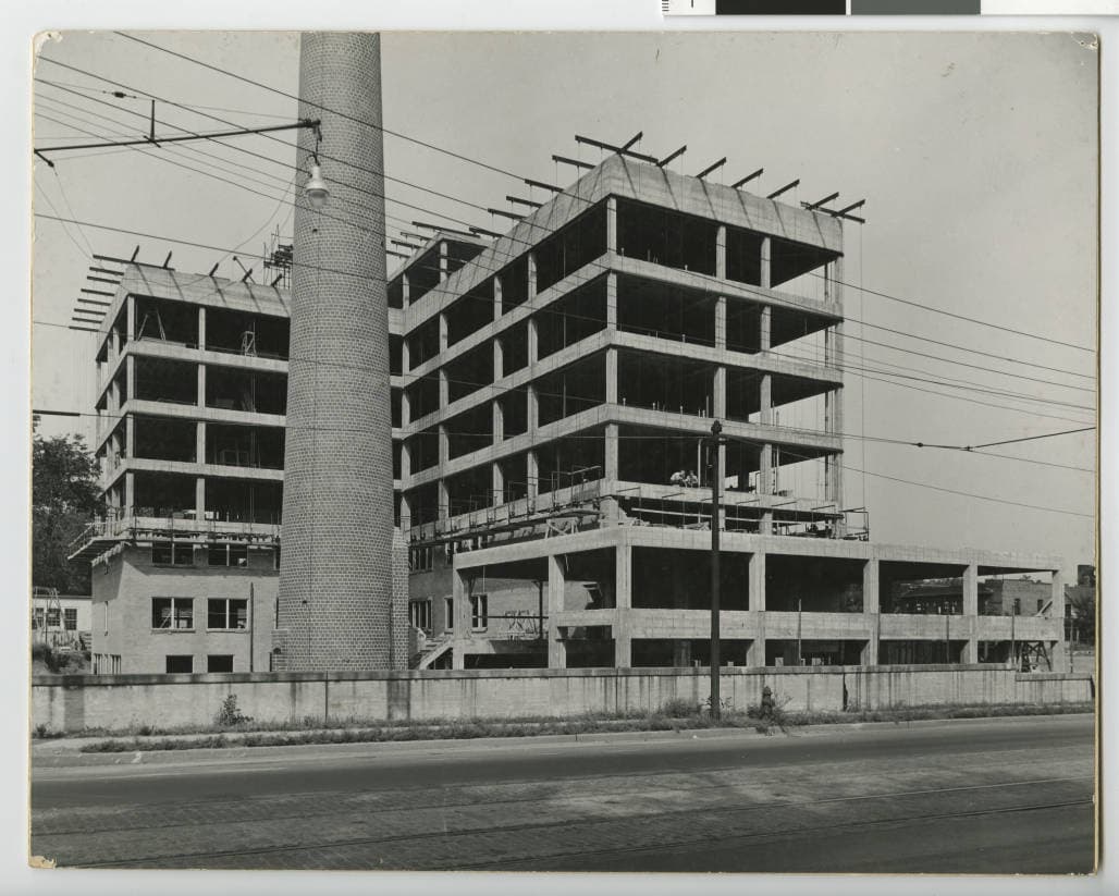 Steel and concrete building frame rising on a construction site