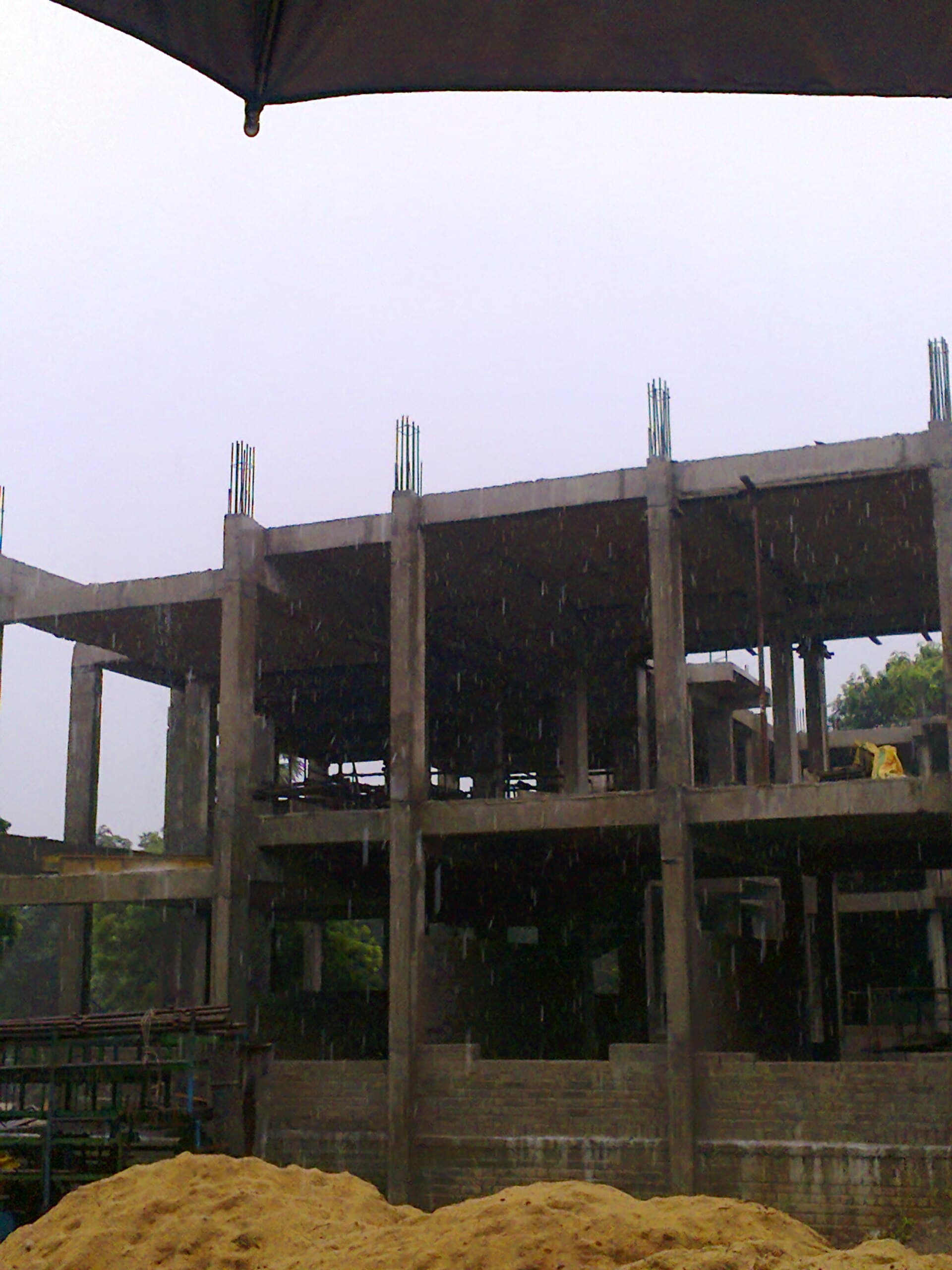 Timber house frame with temporary bracing standing ready for lock-up under a clear sky